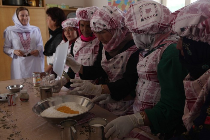 Afghan women attend a baking class at the Bamyan Women's Community Center, located in the Dragon Valley region of Bamyan, Afghanistan. The center was developed and is managed by Arzu Studio Hope, based out of Chicago. The facility also has Afghanistan's only heated laundry room, two classrooms, tea room and offers literacy classes. Founder of Arzu, Connie Duckworth, visited Helmand in search of possible locations to expand the organization. Arzu is a nonprofit organization that provides income to Afghan women by sourcing and selling rugs they weave. In return, the women must attend classes at the community center.