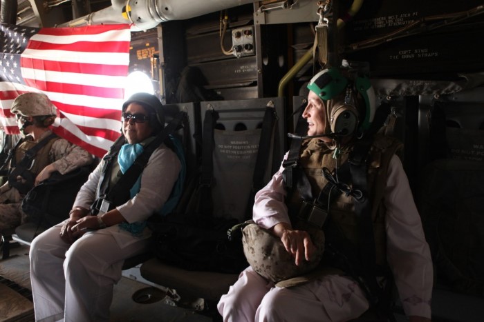 Connie Duckworth, founder of Arzu Studio Hope, and Razia Jan, founder of Razia's Ray of Hope, take a ride on V-22 Osprey on their way to Lashkar Gah, June 8. Duckworth and Jan visited Helmand province to survey potential sites to expand operations like the women's center in Bamyan, Afghanistan. The women's center employs women weavers to create high-end woven rugs. To work for Arzu, women sign a contract agreeing to send all of their children to school until age 15 and take literacy classes themselves. Also, pregnant women and mothers of newborns are to accept transportation to medical care.