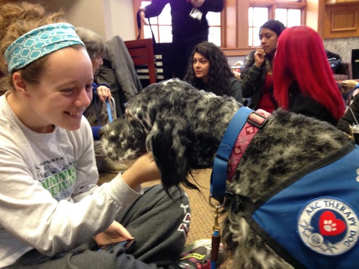 Lily with students at Bay Path University, providing stress relief during finals