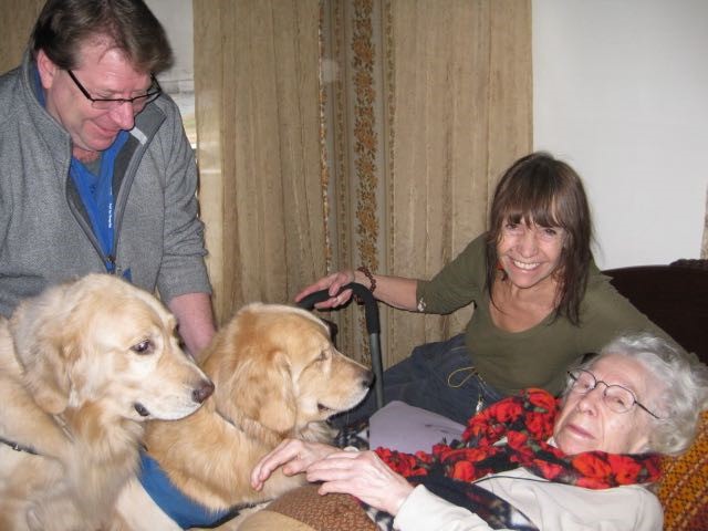 Board member Kevin Russell and his therapy dogs Niles and Carber visit a hospice patient in her home