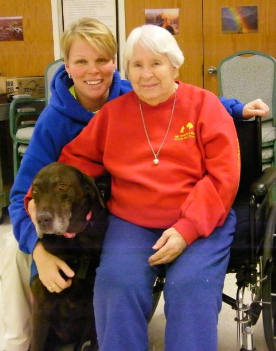 Michelle Karb and her therapy dog Coco visiting a friend in the nursing home