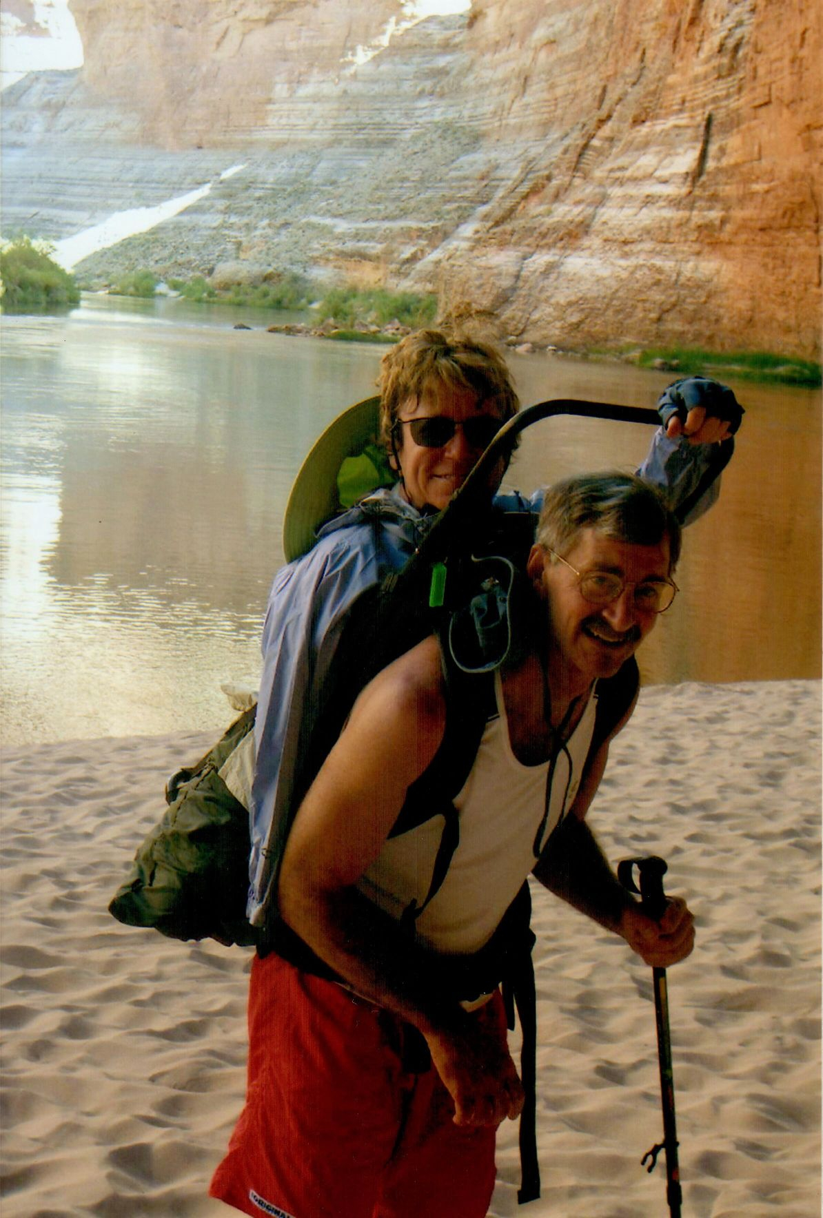 Dave carrying Linda Olson in backpack during 7-day river rafting trip in Grand Canyon.